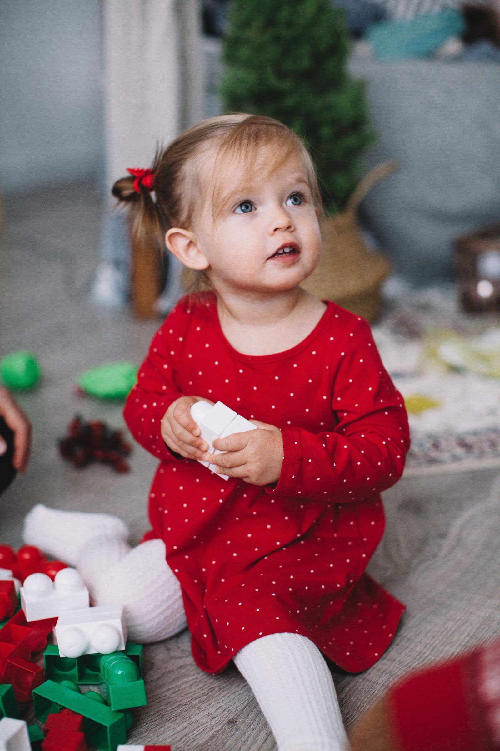 A little girl playing with building blocks