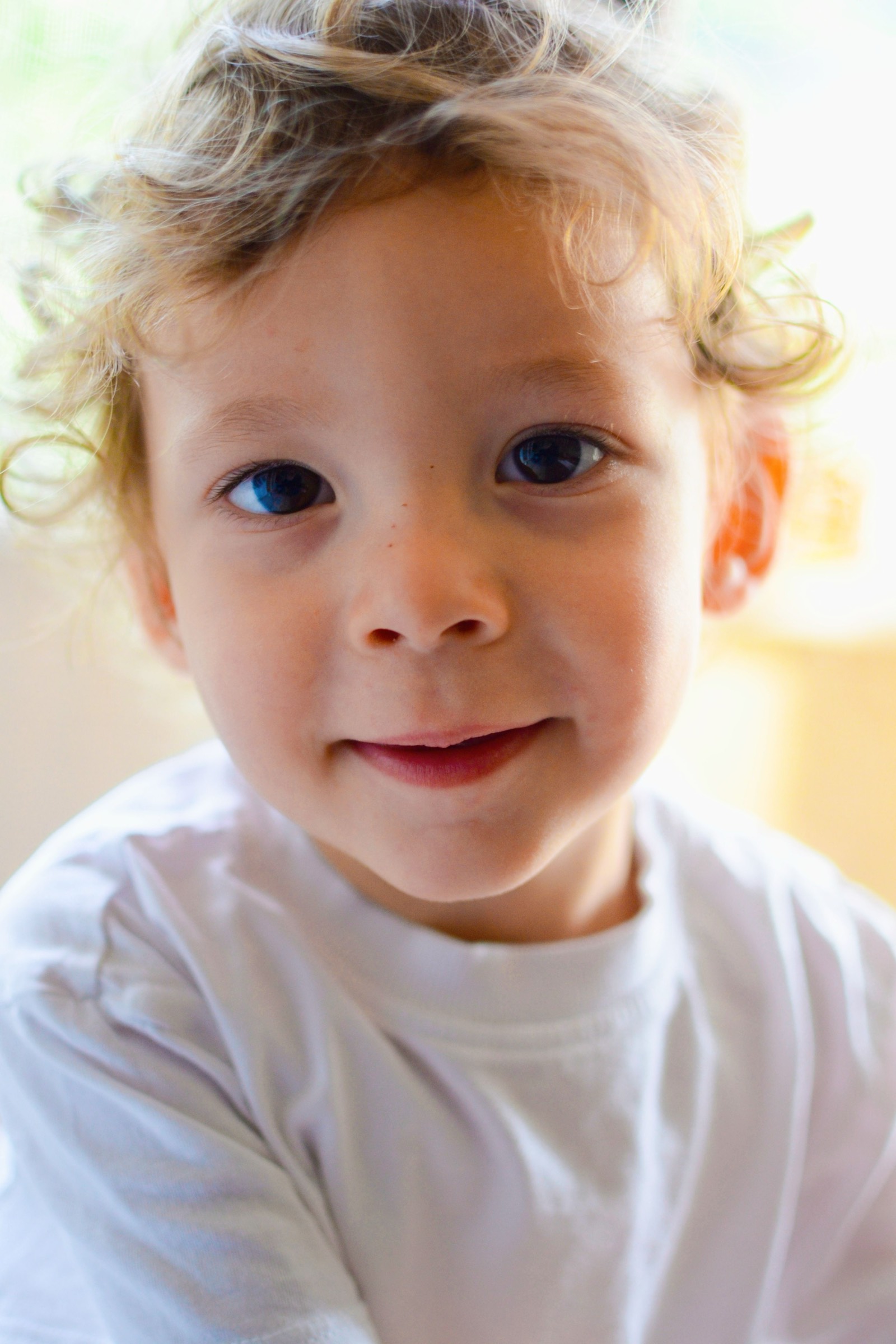 A young child smiling warmly